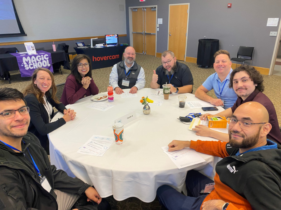Eight attendees working at a round table
